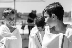 ילדים צוחקים עטופים במגבות אחרי יום קיץ צילום משפחתי טבעי ודוקומנטרי מאת טל גולדשטיין